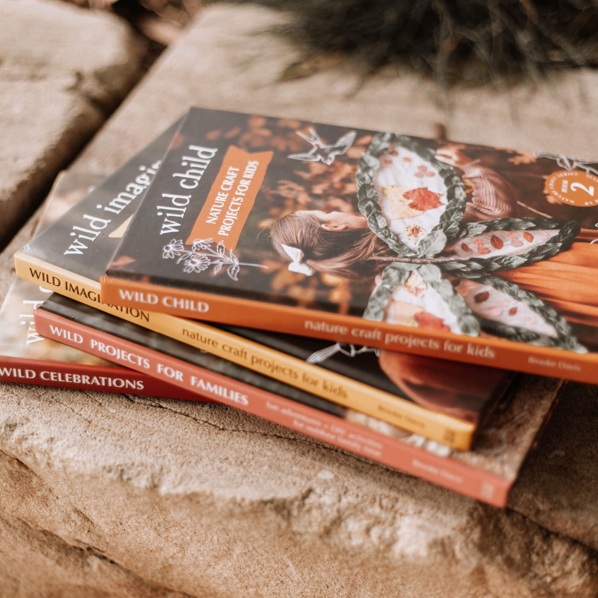 Books stacked on paving are Nature Craft Series by Your Wild Books is printed in Australia using FSC Certified paper.