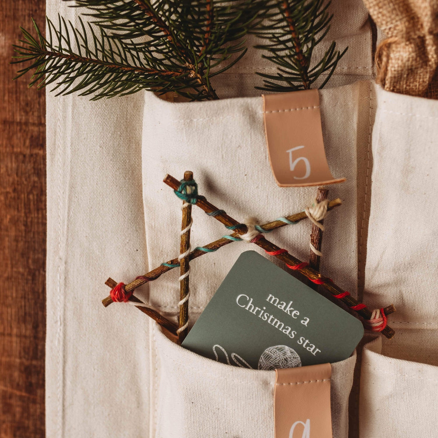 Advent Calendar Cards made in Australia by Your Wild Books to encourage creativity and family connection. Card says Make a Christmas star and is inside a pocket of the Fabric advent calendar.