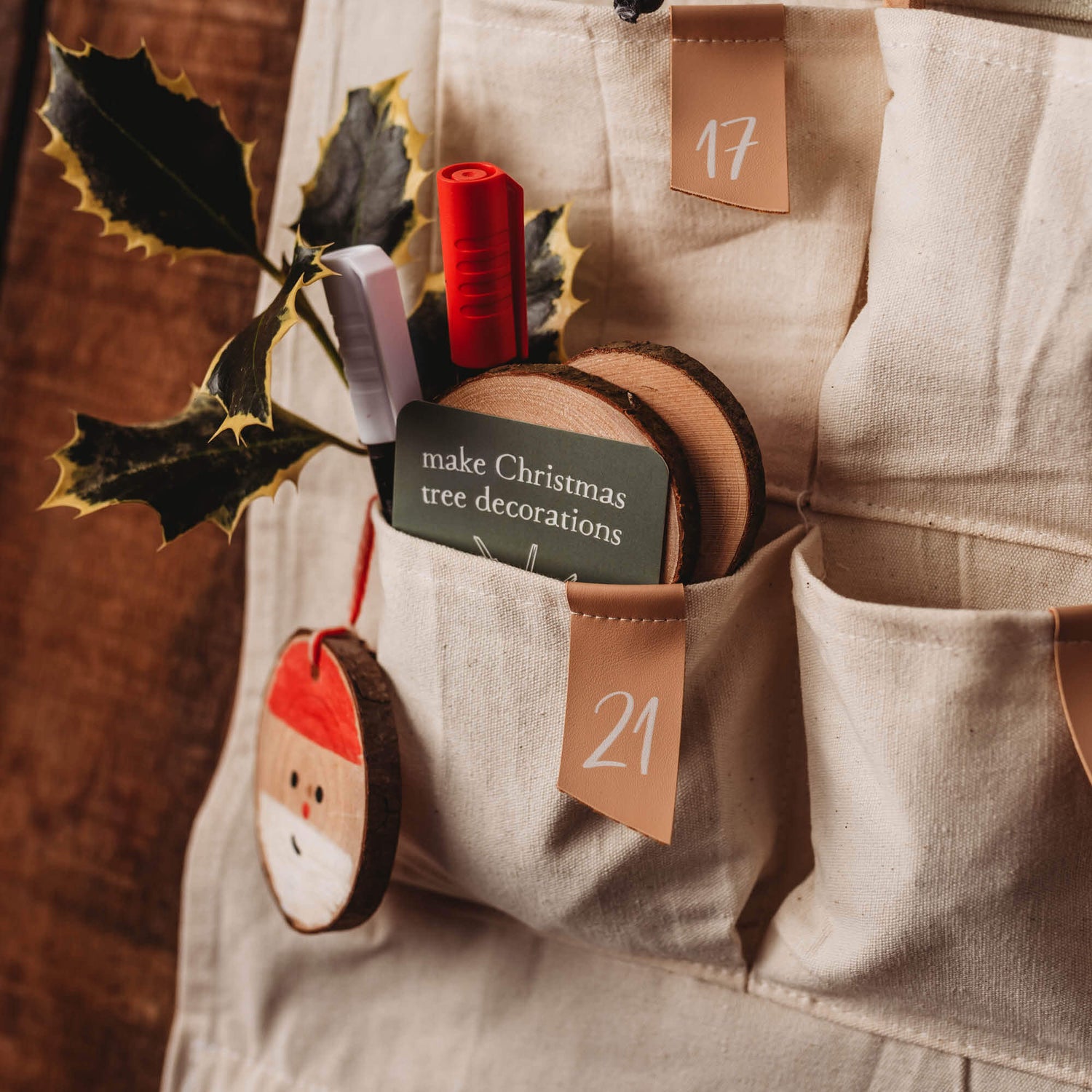 Advent Calendar Cards made in Australia by Your Wild Books to encourage creativity and family connection. Card says Make Chrismas tree decorations and is shown in the pocket of the Fabric Advent Calendar.