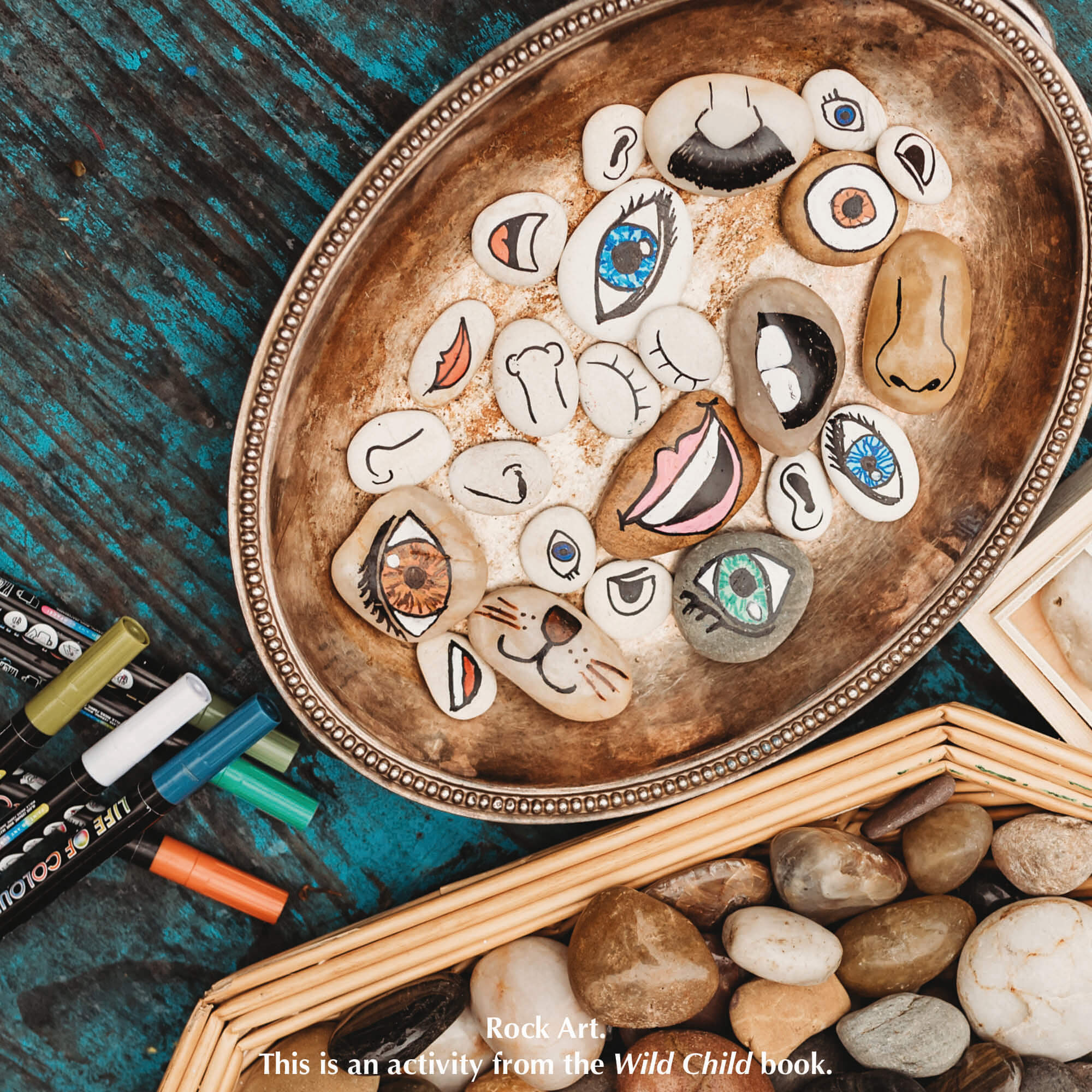 Rock art with facial features, a nature craft activity from Your Wild Books that have been decorated with paint pens from Life of Colour