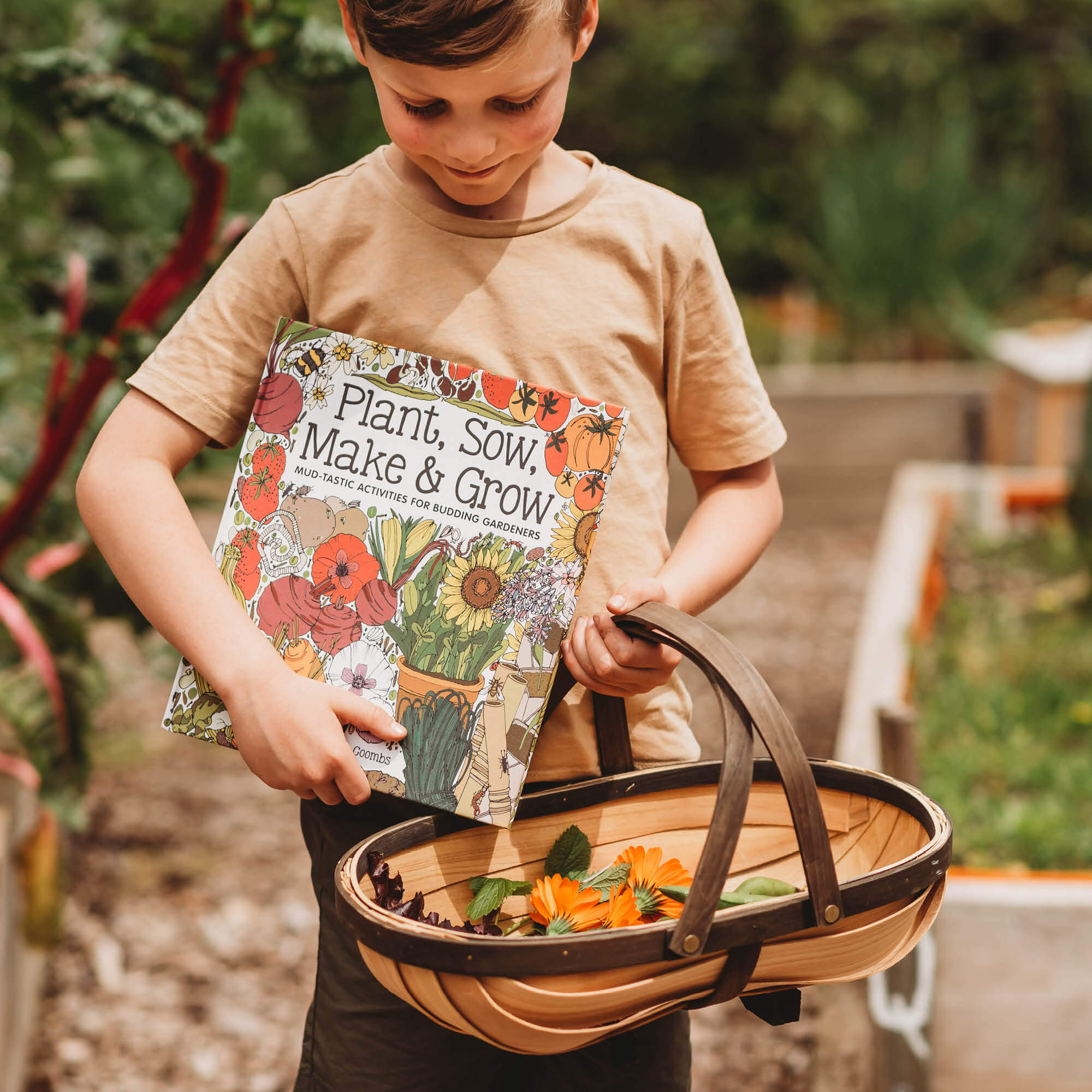Boy holding Plant, Sow, Make and Grow kids gardening book by Esther Coombs from Your Wild Books.
