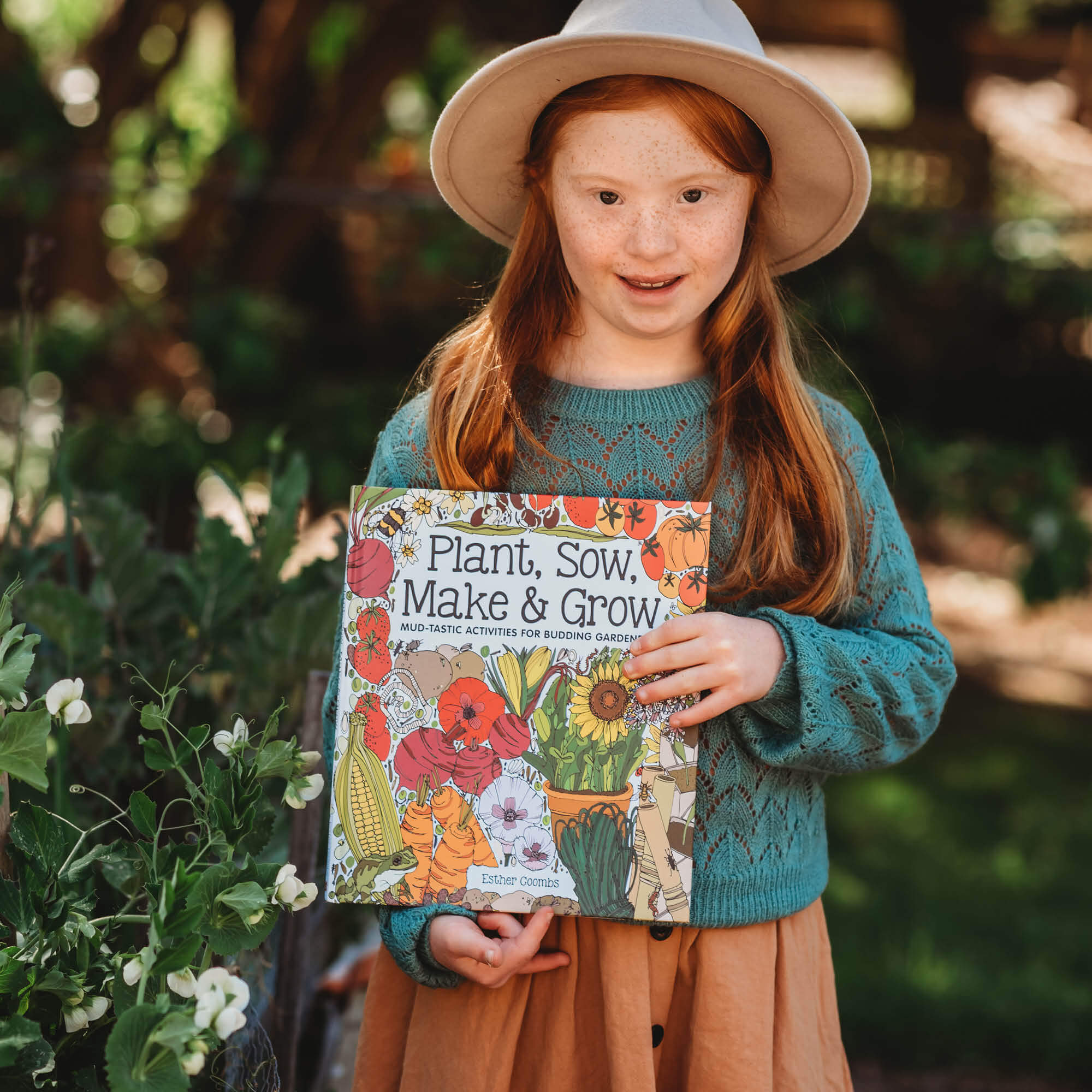 Girl holding Plant, Sow, Make and Grow kids gardening book by Esther Coombs from Your Wild Books.
