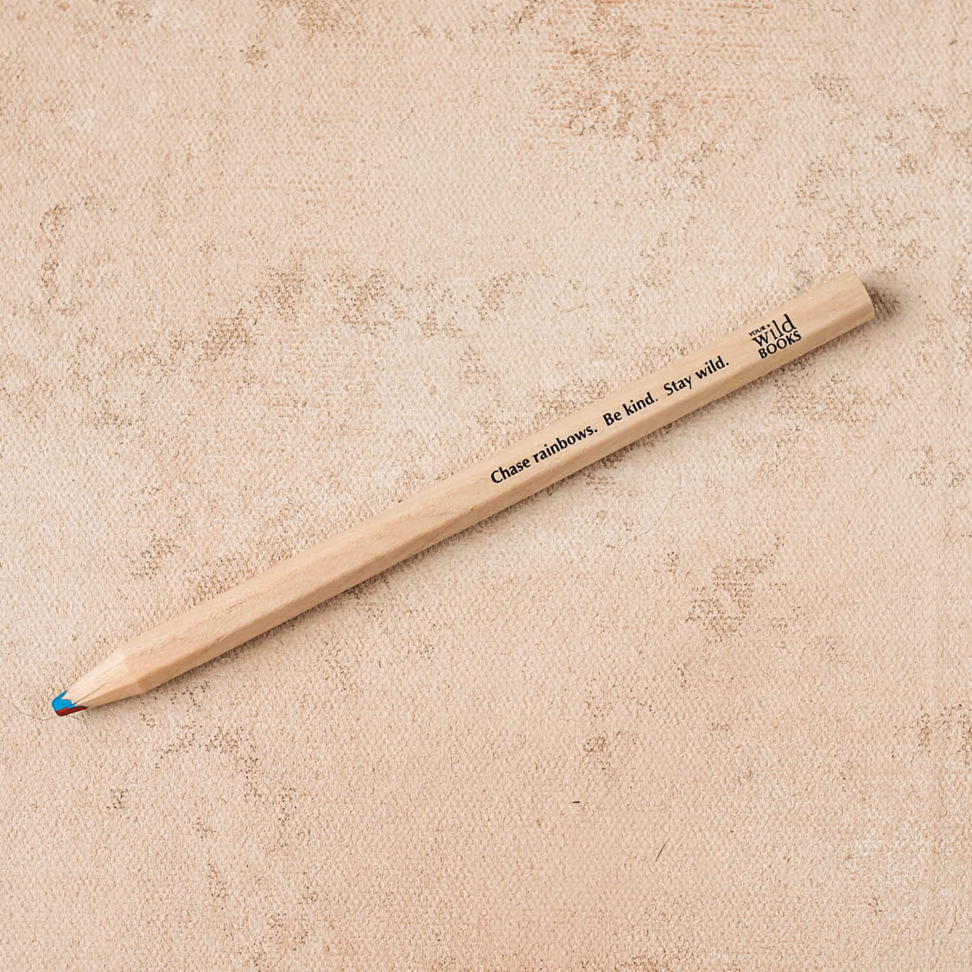 4 colour rainbow pencil with thick FSC certified timber casing for easy grip. Engraved with quote - Chase rainbows. Be kind. Stay wild. And the Your Wild Books logo.