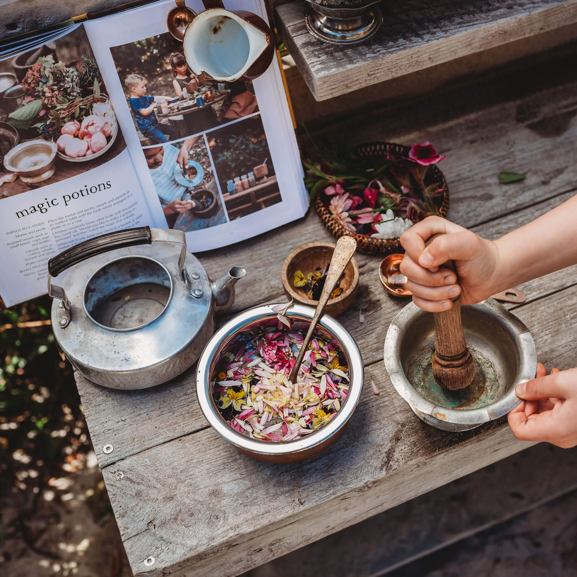 Child making magic potions with nature and flower petals from Wild Imagination, nature craft projects for kids book, made in Australia by Your Wild Books.
