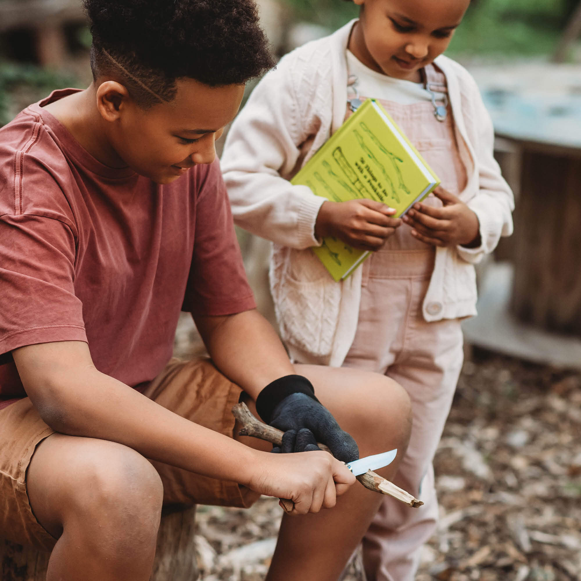 Children in nature with whittling knife and 50 things to do with a penknife book wood whittling book for kids wood working projects from Your Wild Books