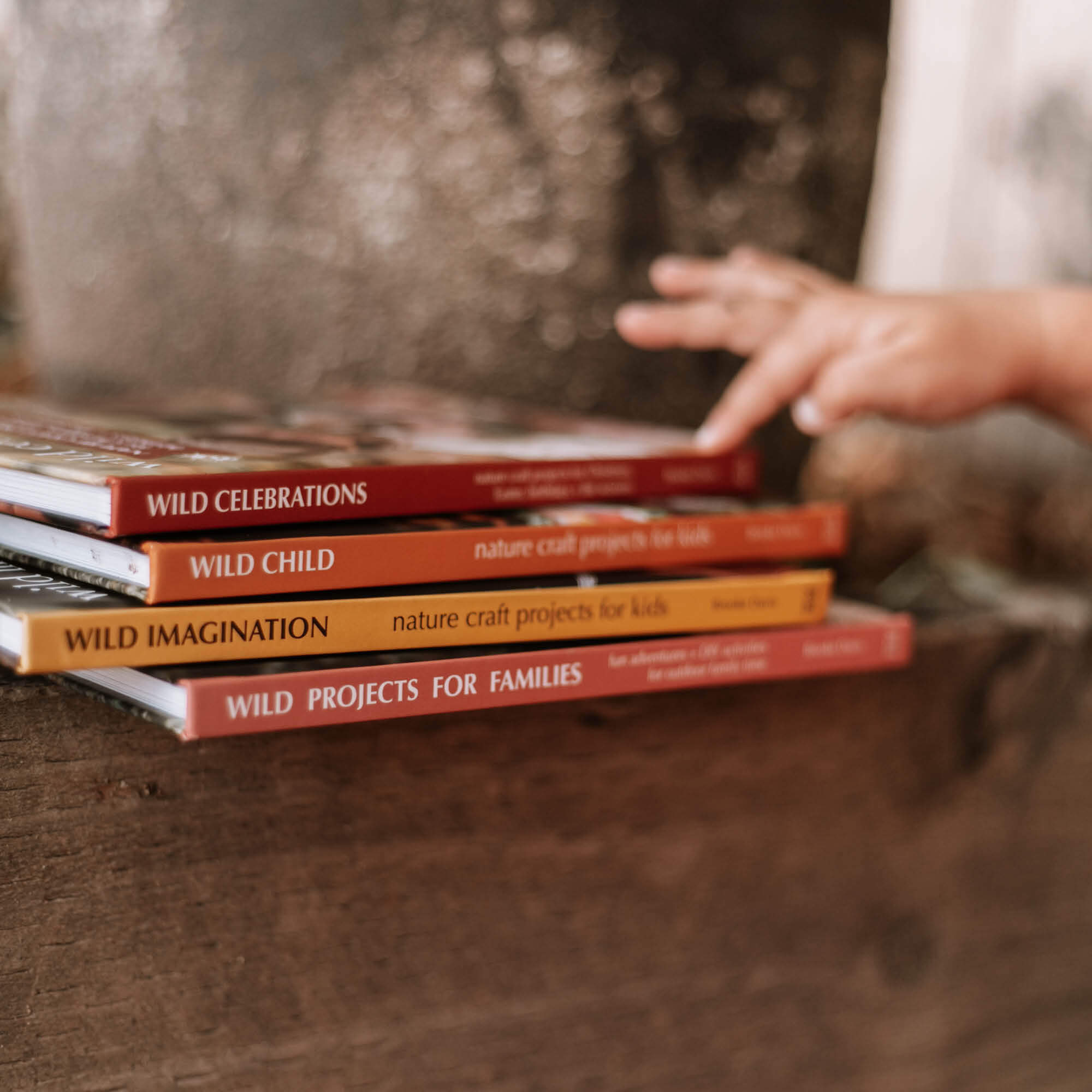 Child pointing at books from the Nature Craft Series by Your Wild Books is printed in Australia using FSC Certified paper.