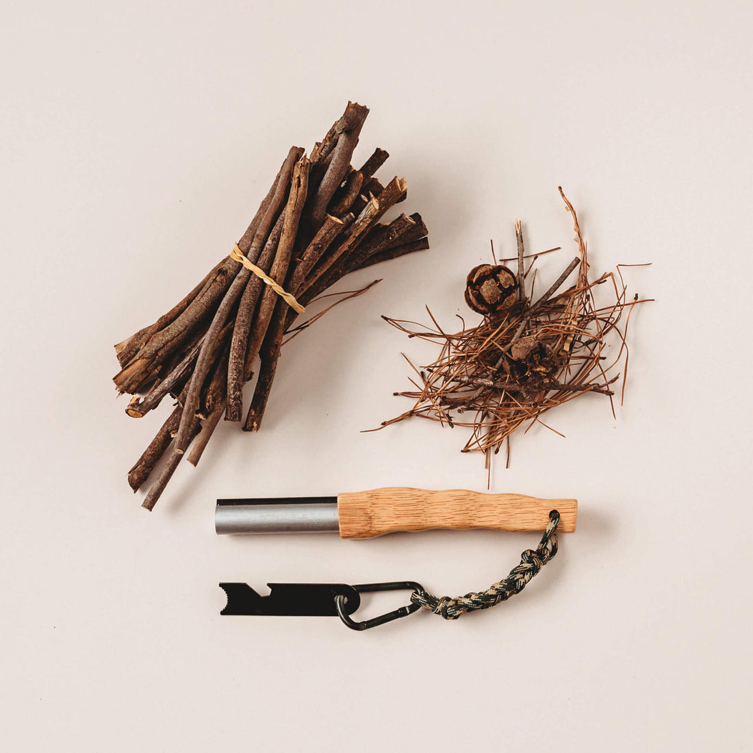 Flatlay of fire starter with wooden handle with kindling made by Your Wild Books