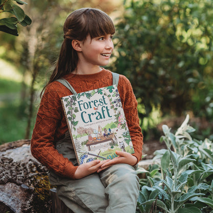 Girl in nature holding Book Forest Craft, a child&
