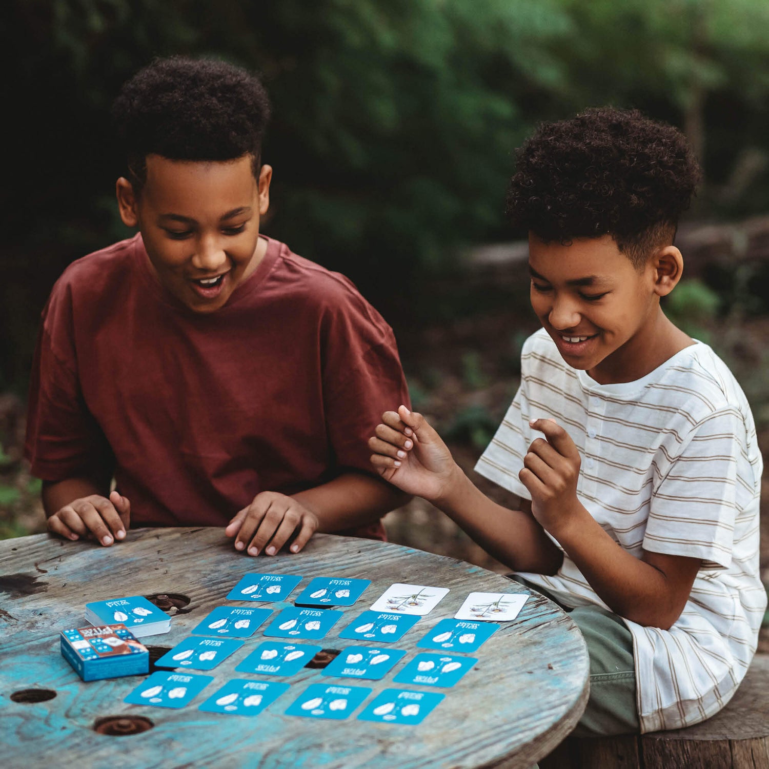 Two boys playing Your Wild Memory Card Game with nature inspired illustrations. Made in Australia by Your Wild Books.