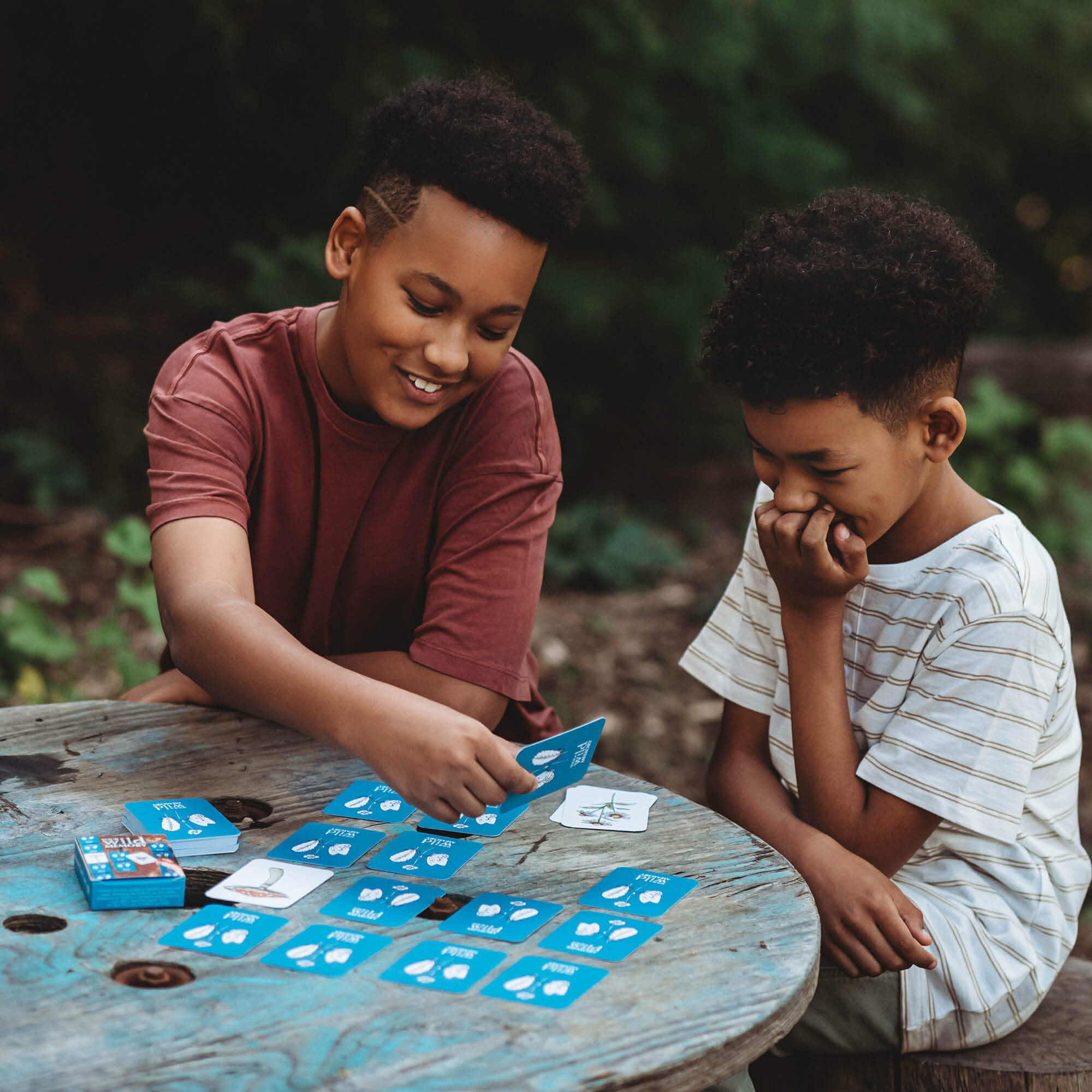 Two boys playing Your Wild Memory Card Game with nature inspired illustrations. Made in Australia by Your Wild Books.