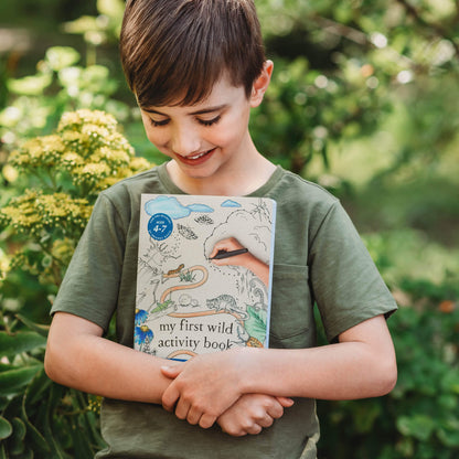 Boy holding My First Wild Activity Book made in Australia by Your Wild Books for prereaders