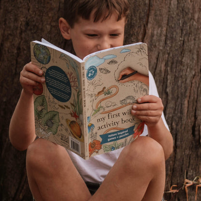 Boy holding My First Wild Activity Book made in Australia by Your Wild Books for prereaders