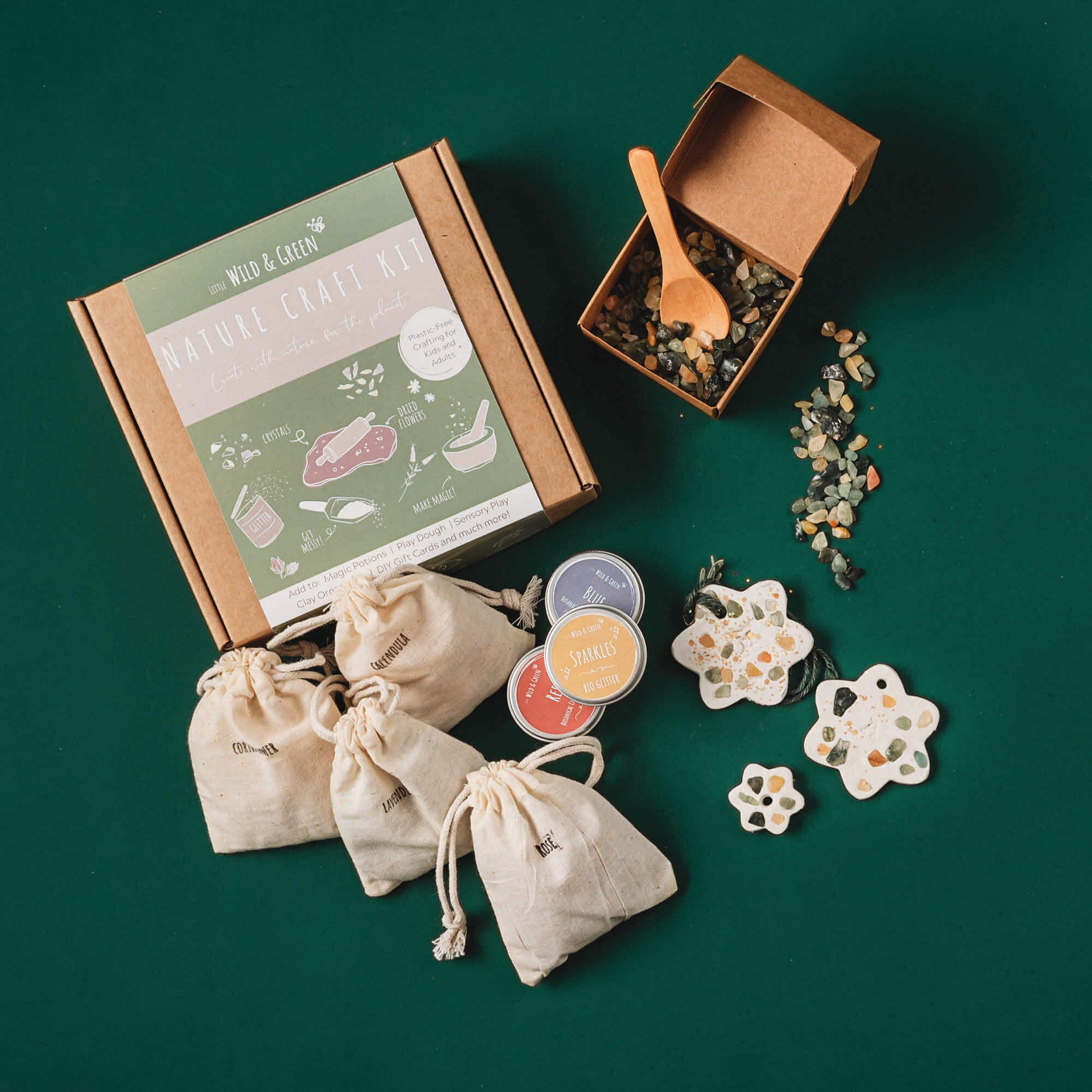 Nature craft kit by Little Wild and Green made with all natural materials including 4 bags of petals, 2 paint powders, 1 eco glitter, a box of crystal chips and a wooden spoon. perfect for nature crafting for kids including playdough, clay and magic potions from Your Wild Books