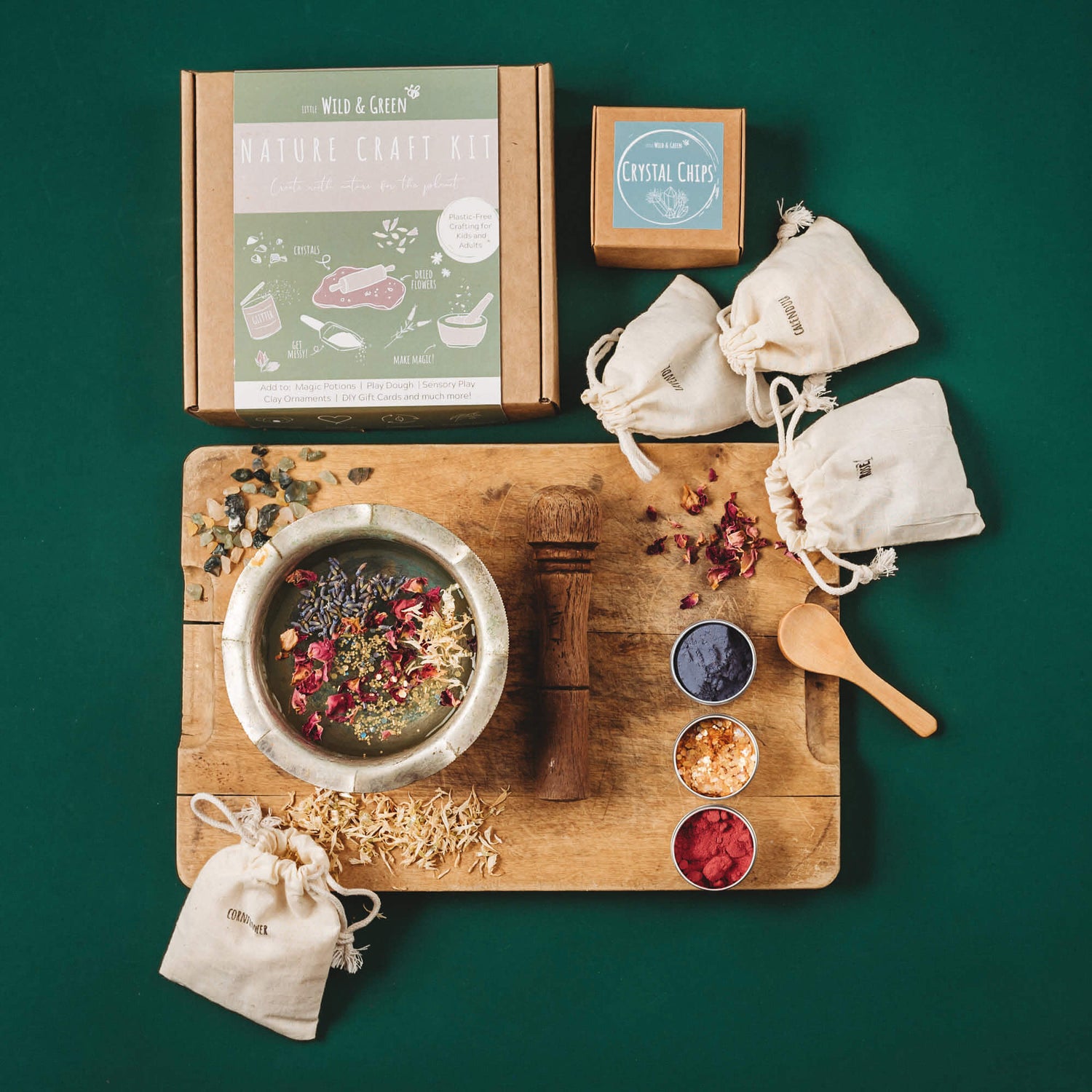 Nature craft kit by Little Wild and Green made with all natural materials including 4 bags of petals, 2 paint powders, 1 eco glitter, a box of crystal chips and a wooden spoon. perfect for nature crafting for kids including playdough, clay and magic potions from Your Wild Books