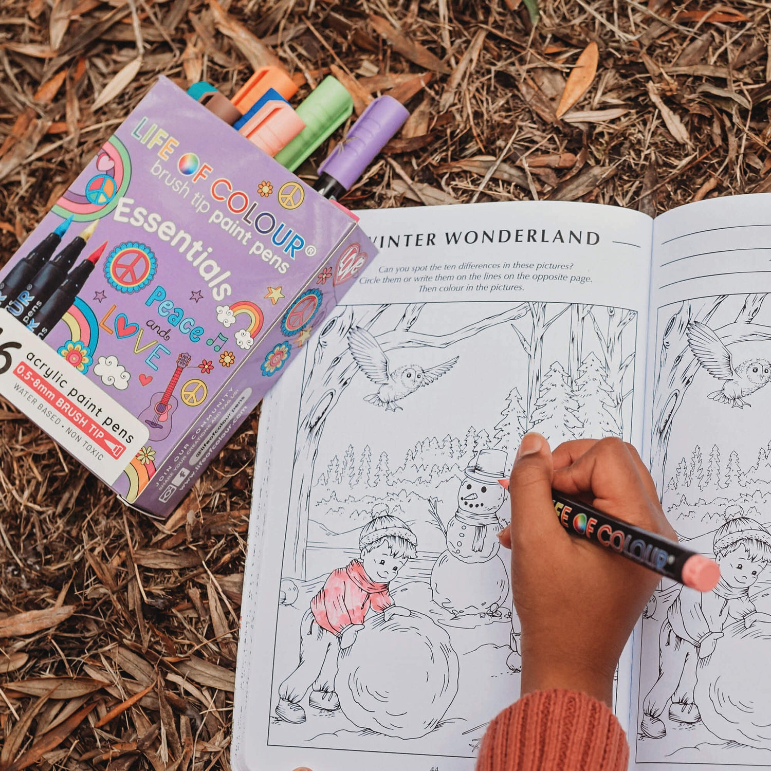 Girl drawing in activity book from Your Wild Books using Brush tip paint pens by Life of Colour.