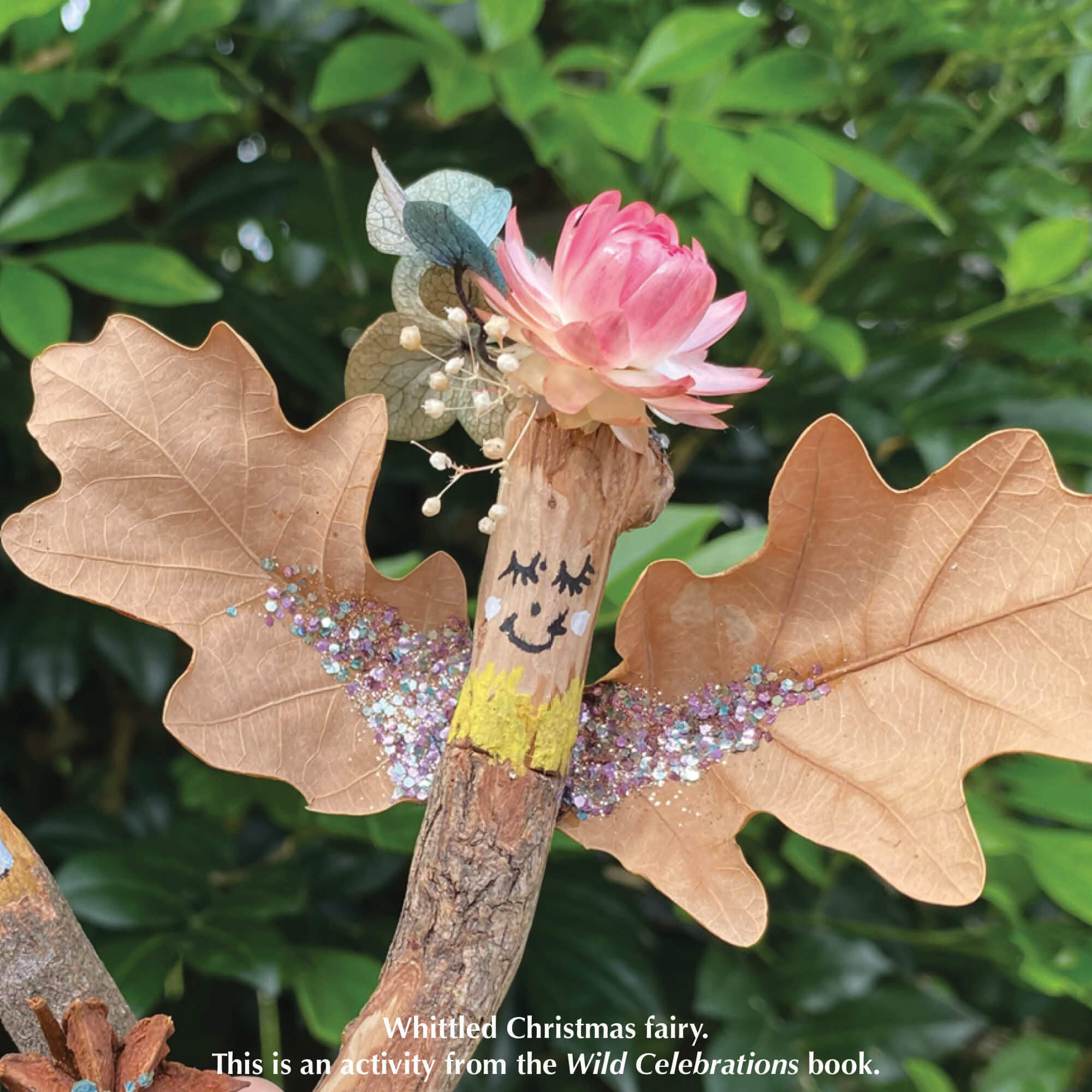 Whittled Christmas fairy from Your Wild Books decorated with paint pen, eco glitter, leaves and flowers