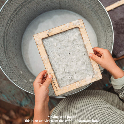 Child making paper with the Paper Making Bundle includes Wild Celebrations book, Paper Making kit from Poppy and Daisy and two packets of seeds from Heirloom Harvest. All products are made in Australia.