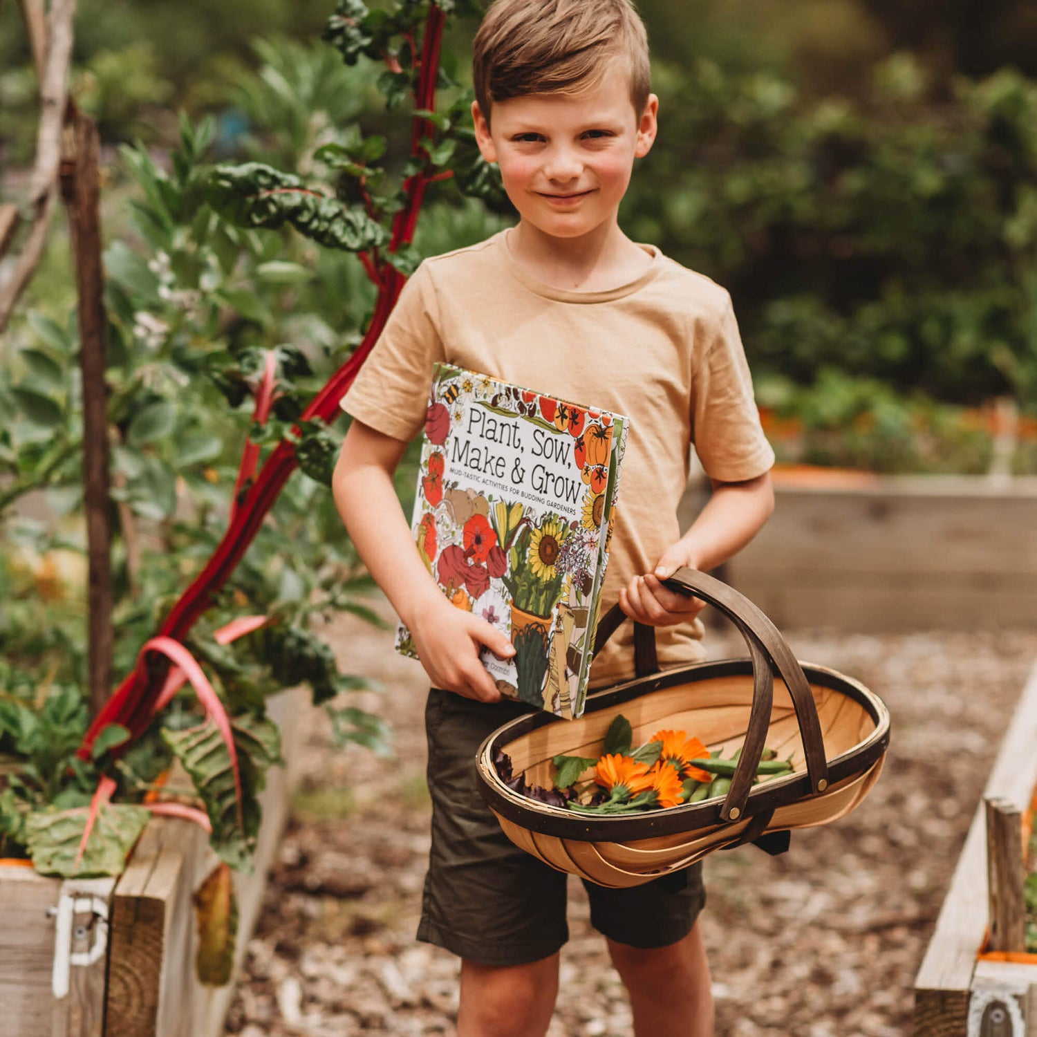 Boy holding Plant, Sow, Make and Grow kids gardening book by Esther Coombs from Your Wild Books.