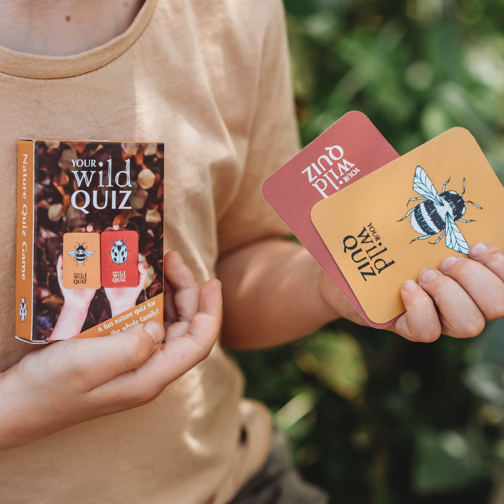 Child holding a nature inspired card game, Your Wild Quiz. Made in Australia by Your Wild Books.