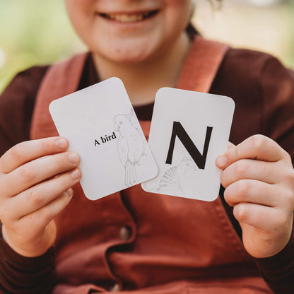 Child playing a nature inspired card game, Your Wild Quiz. Made in Australia by Your Wild Books.