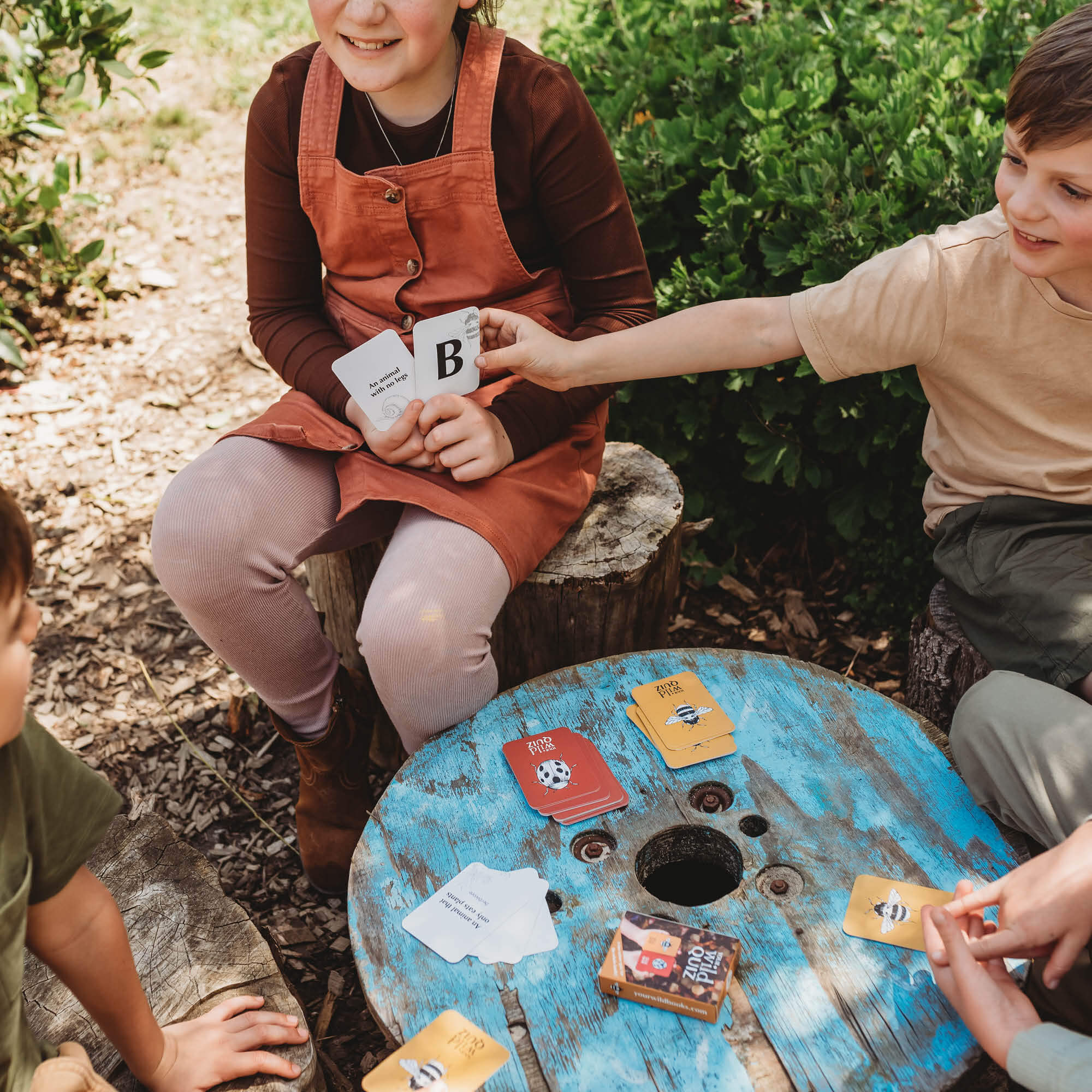 Children playing a nature inspired card game, Your Wild Quiz. Made in Australia by Your Wild Books.