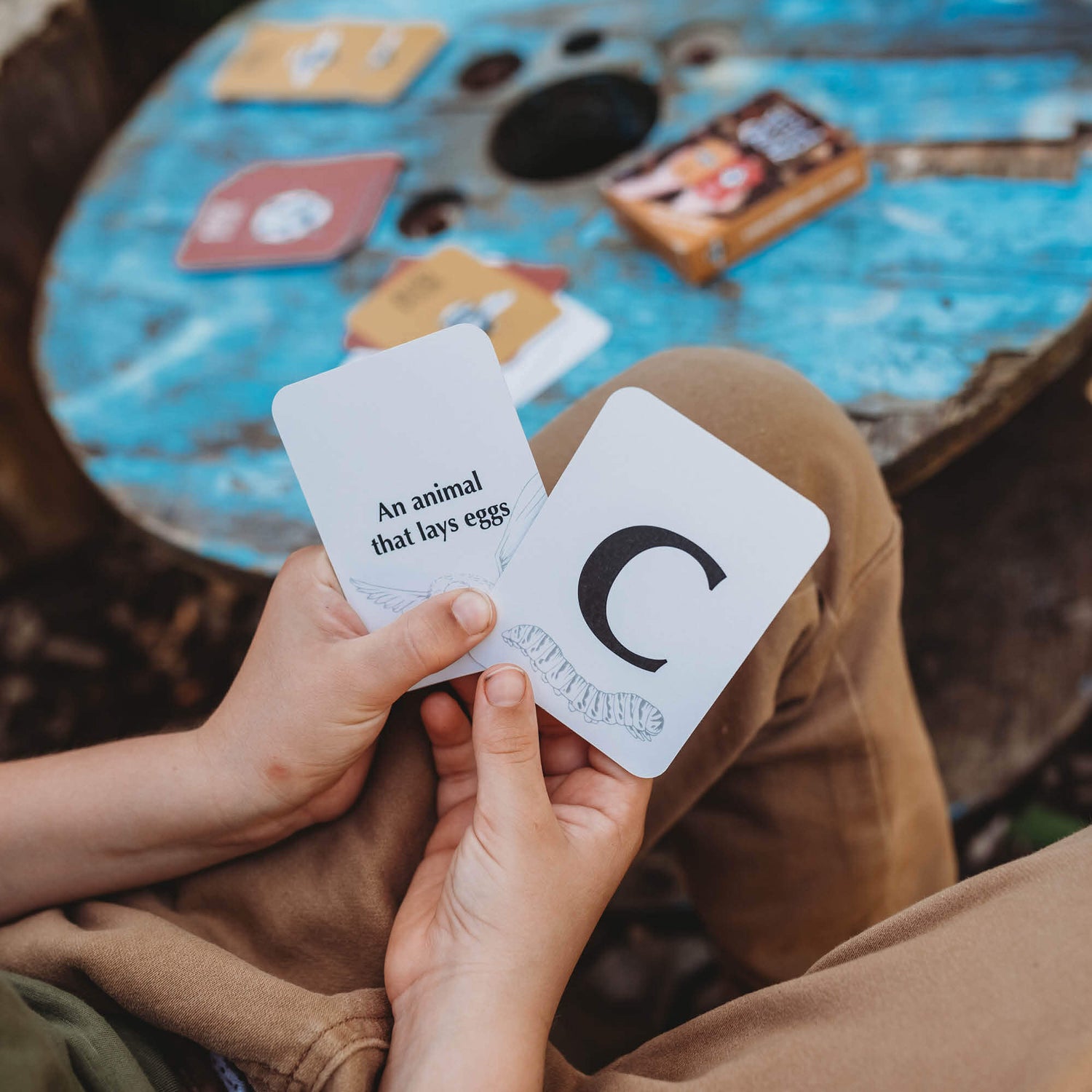 Children playing a nature inspired card game, Your Wild Quiz. Made in Australia by Your Wild Books.