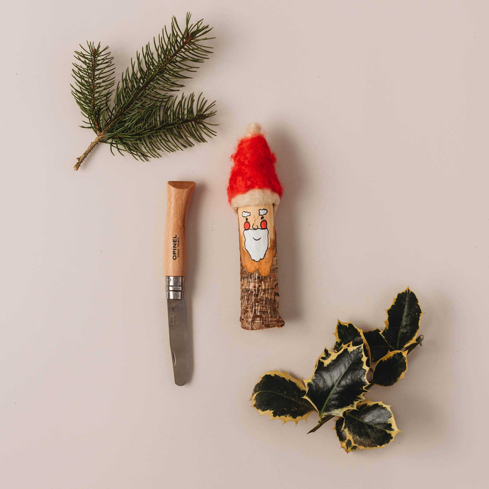 Santa made from a whittled stick, Wood whittling knives for kids for all your nature craft projects, suitable for beginners and advanced woodworkers. Made by Opinel from Your Wild Books.