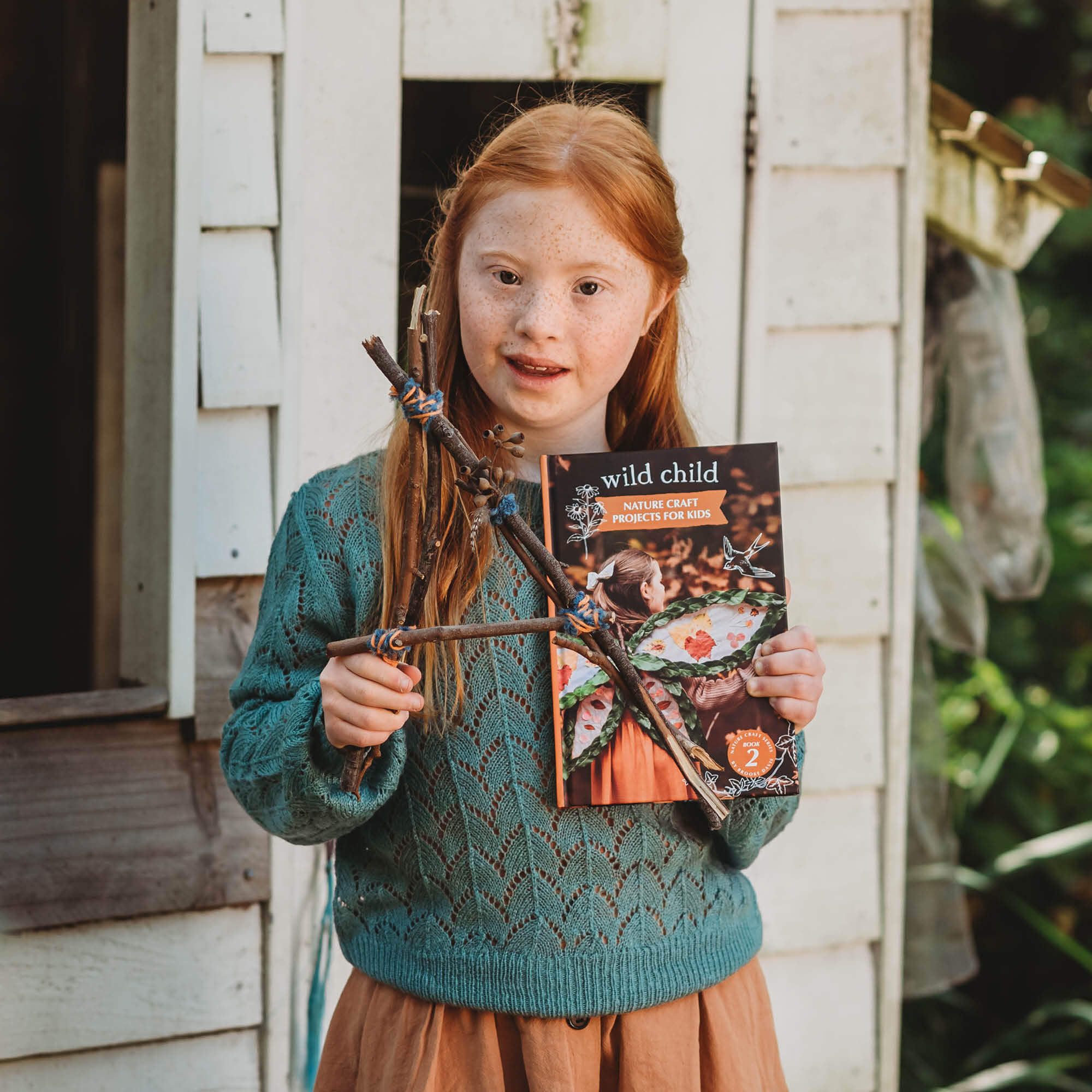 Child holding letter &