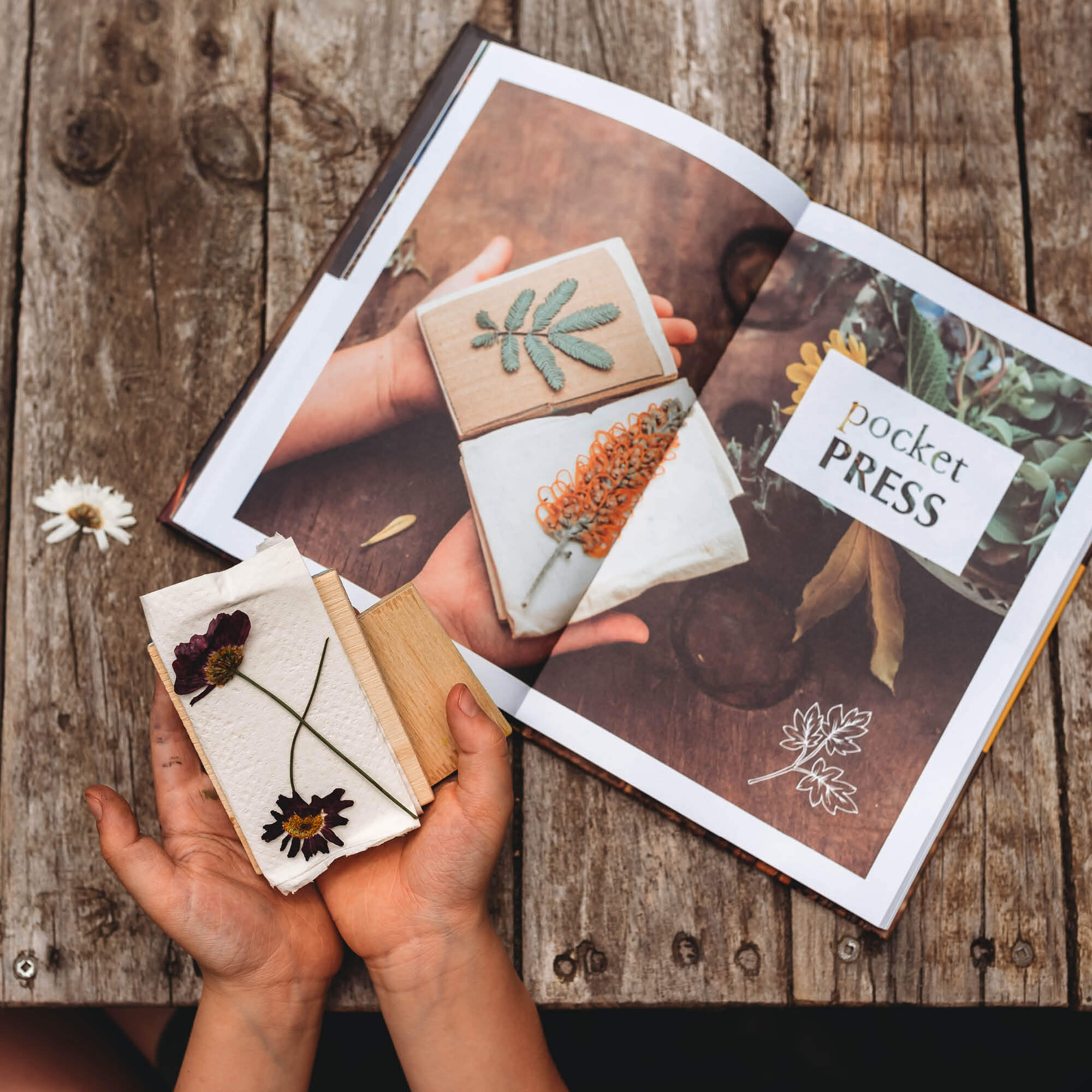 Child holding a pocket flower press they made following step by step instructions inside Wild Imagination, nature craft projects for kids book, made in Australia by Your Wild Books. 