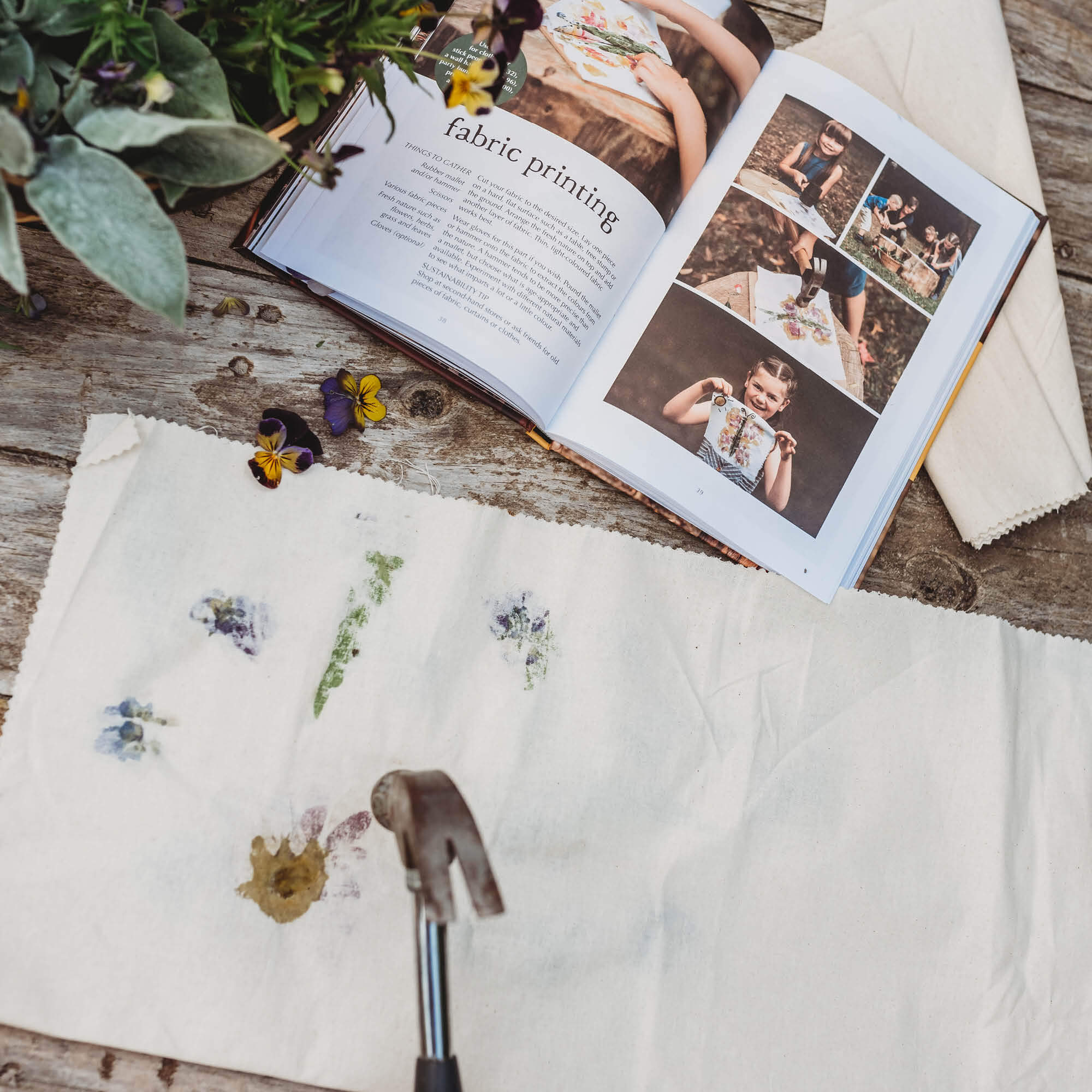 Child using a hammer to print on fabric with flowers using step by step instructions from Wild Imagination, nature craft projects for kids book, made in Australia by Your Wild Books. 