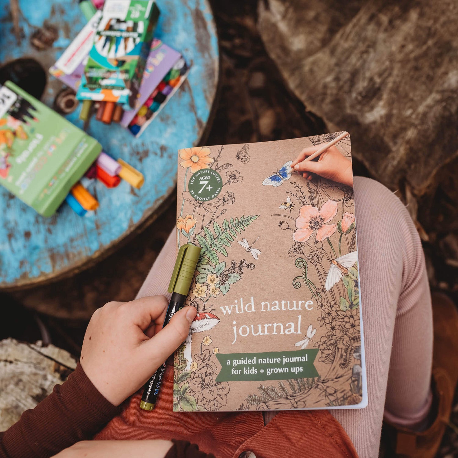 Child holding Wild Nature Journal, a guided nature journal for kids and grown ups is made in Australia by Your Wild Books.