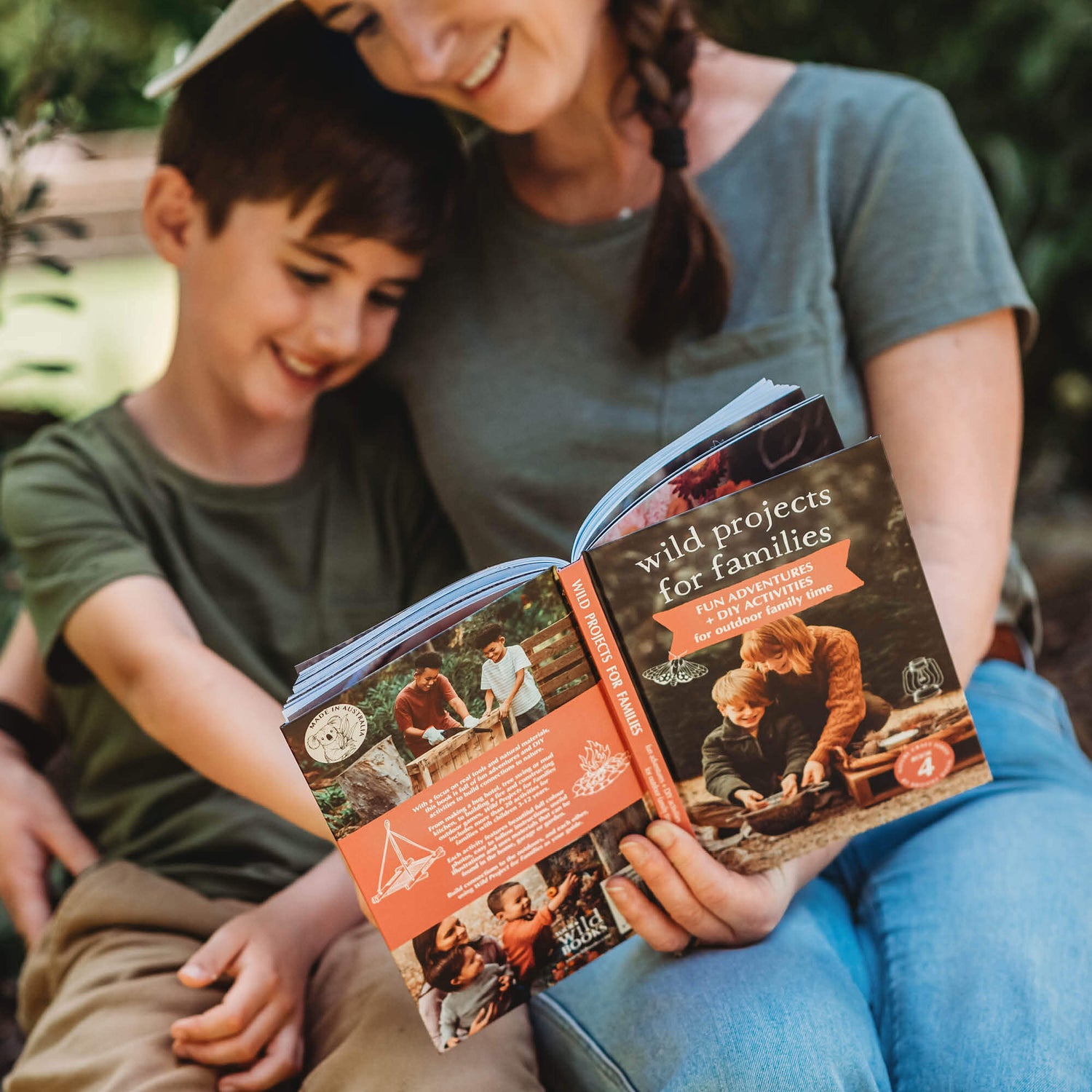 Parent and child reading Wild Projects for Families book has fun adventures and DIY activities for family outdoor time, is made in Australia by Your Wild Books.