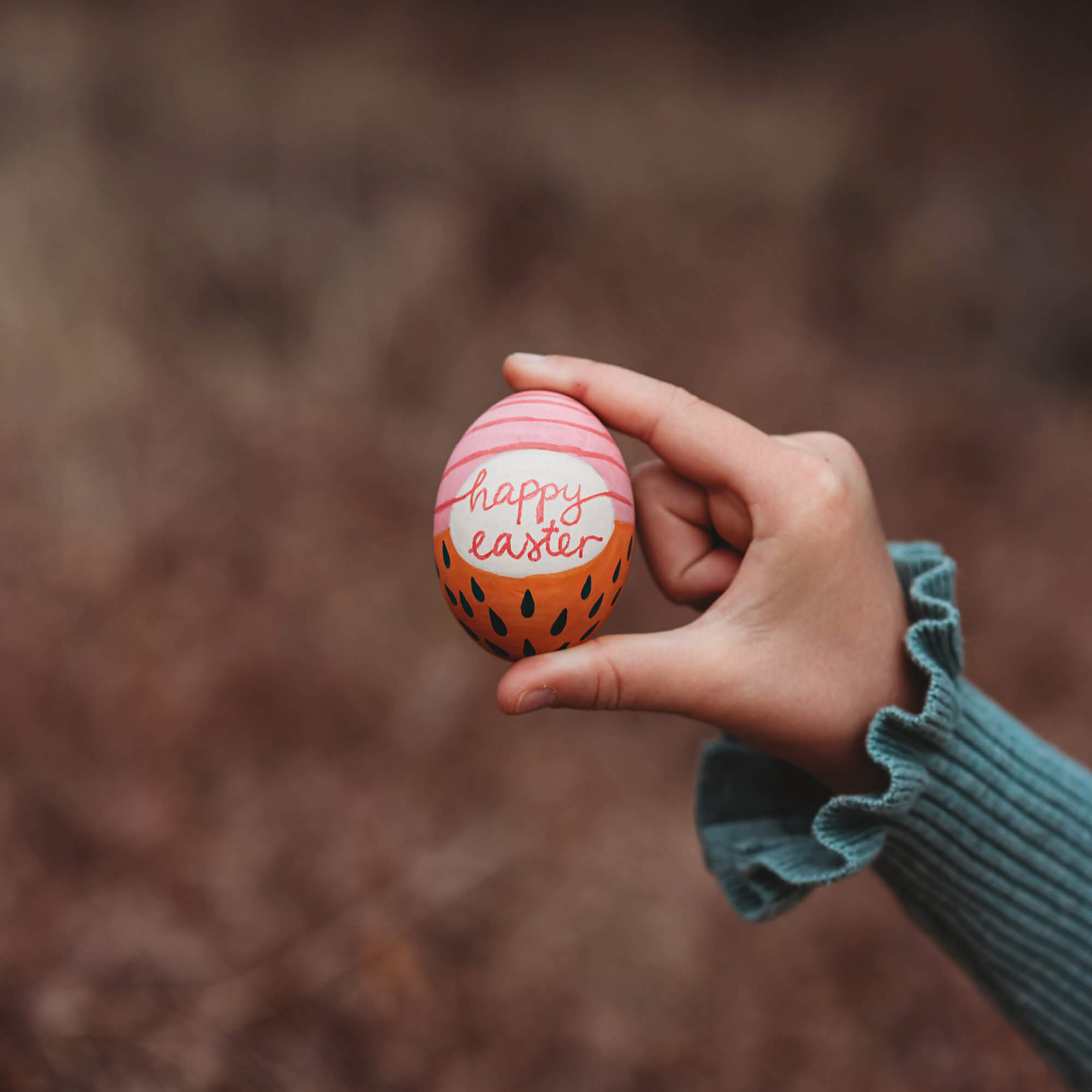 Large wooden eggs decorated with paint pens in Easter theme sugar free alternative to Easter eggs made by Your Wild Books