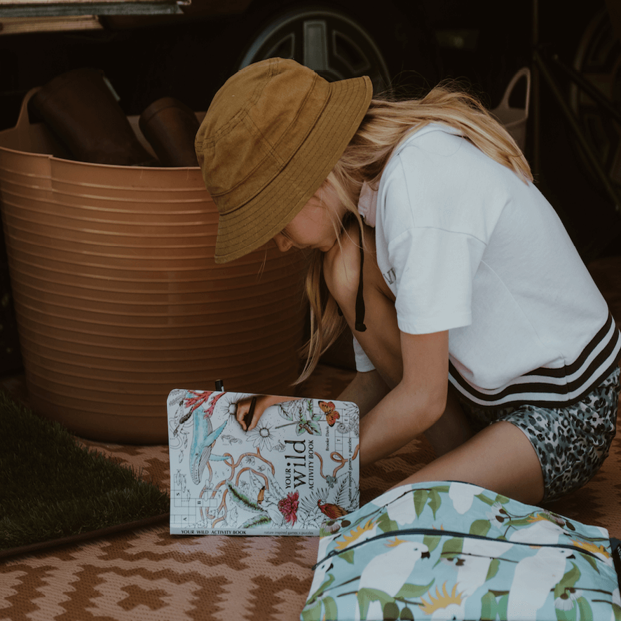 Girl doing activity from Your Wild Activity Book, nature inspired games and puzzles, made in Australia by Your Wild Books.