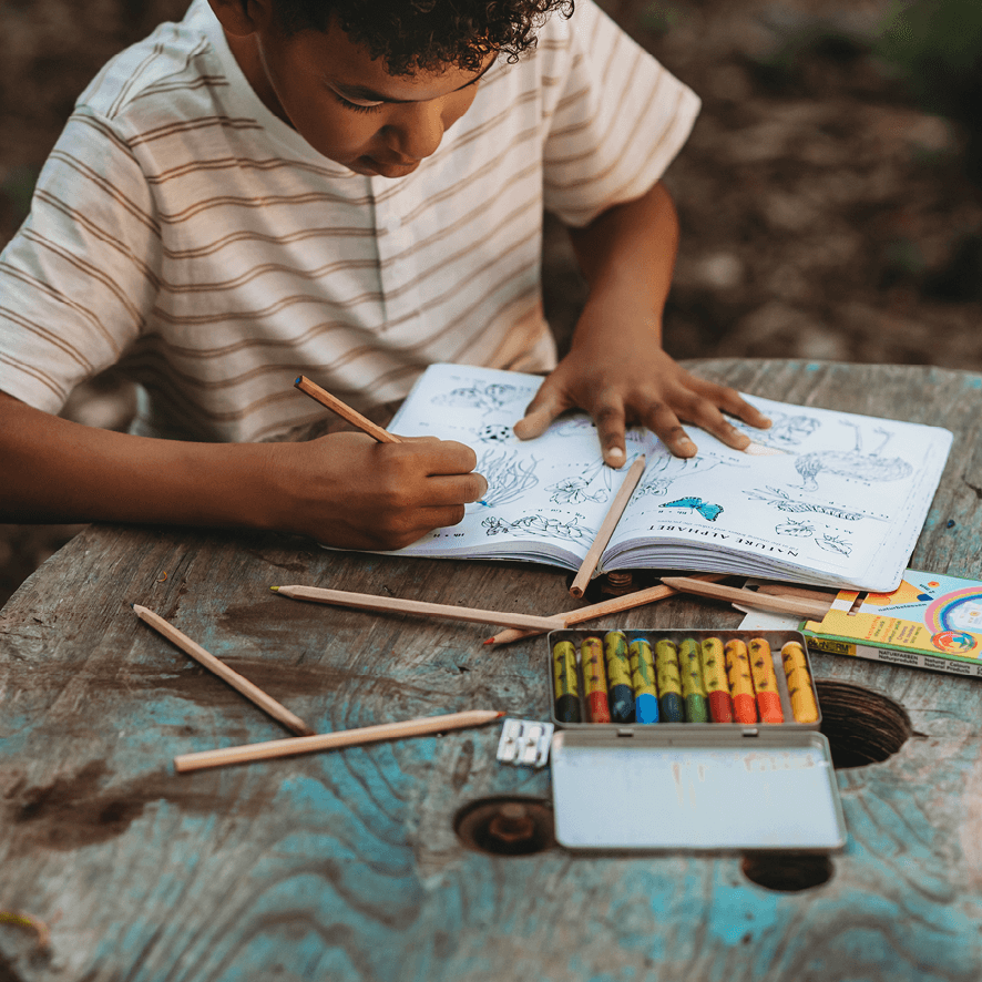 Boy doing colouring activity from Your Wild Activity Book, nature inspired games and puzzles, made in Australia by Your Wild Books.