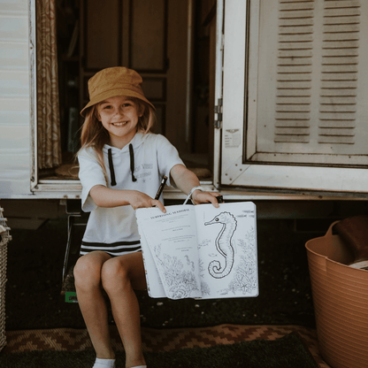 Girl showing a dot to dot activity from Your Wild Activity Book, nature inspired games and puzzles, made in Australia by Your Wild Books.
